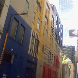 an alleyway, with one wall adorned in colorful patterns